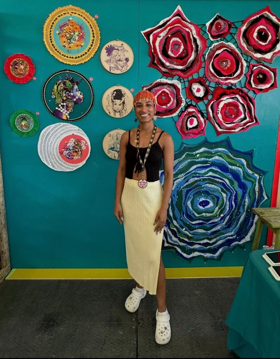 Kokab Zohoori-Dossa in front of her wall textile display at the Cultural Exchange Artist Demonstration Tent