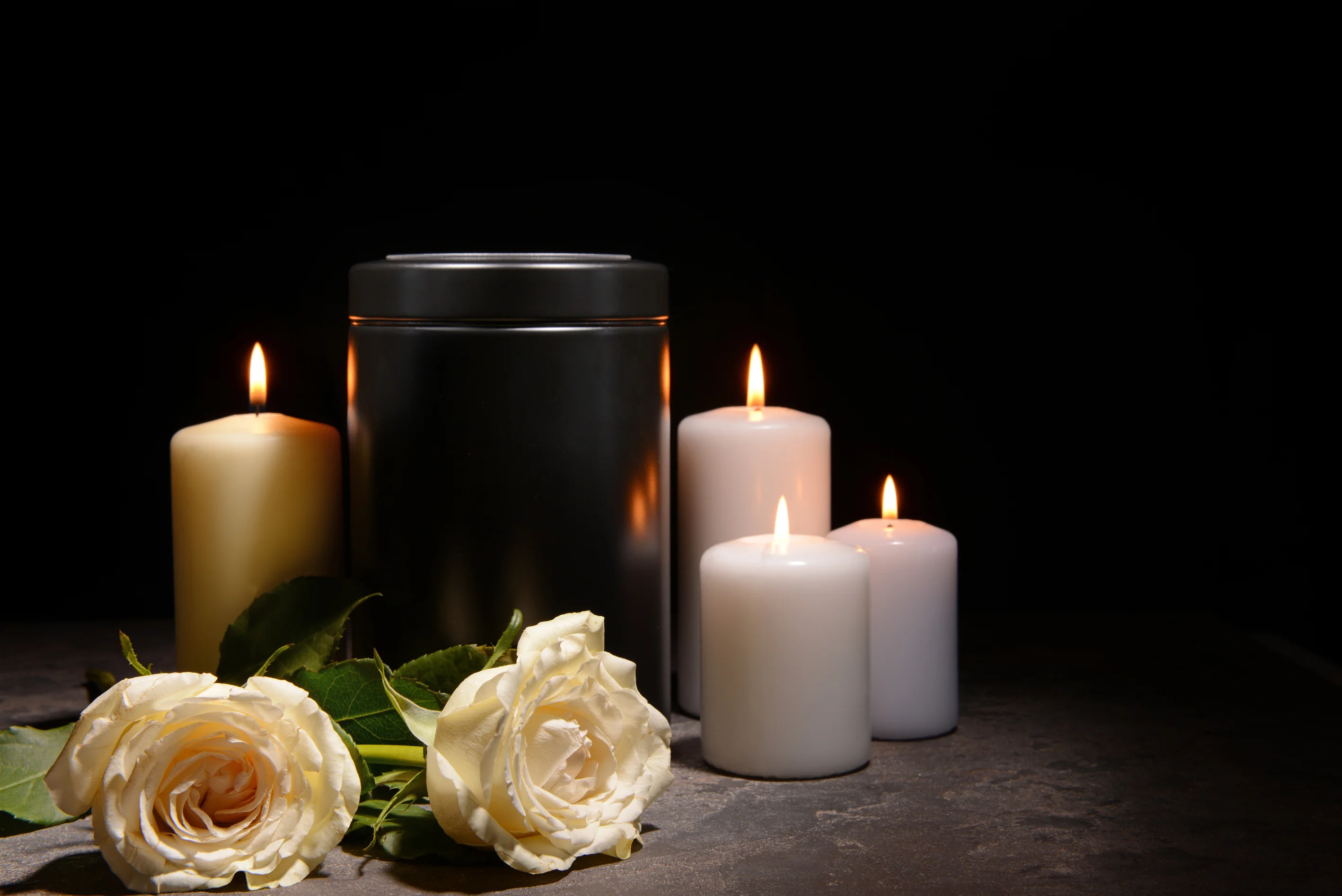 Elegant premium cremation urn resting gently on a pristine Jamaican beach at sunset